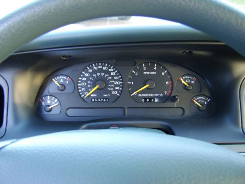 1996 Mercury Grand Marquis - The interior dashboard gauges show the speedometer, tachometer, fuel level, oil pressure, and engine temperature.