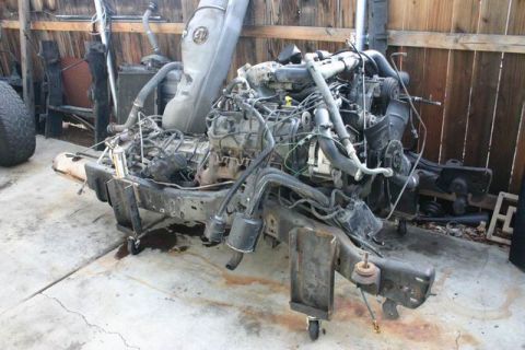 1991 Ford Bronco - Engine and chassis assembly, possibly from a Ford Bronco, with a Supermotors logo visible at the bottom right.
