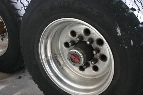 1991 Ford Bronco - The image shows a close-up view of heavy-duty truck wheels and tires, with visible tire brand markings.