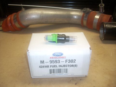 1991 Ford Mustang - A Ford Racing 42#/HR Fuel Injector (8) is shown with its packaging and a large intake pipe.