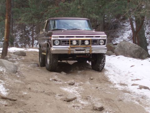 1979 Ford Bronco - This 1978 Ford Bronco navigates a rocky, snow-dusted trail in a wooded area.