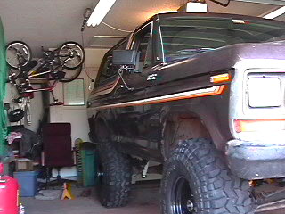 1979 Ford Bronco - This dark purple 1978-1979 Ford Bronco is shown in a garage with bicycles hanging overhead.