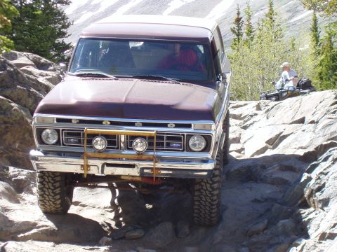 1979 Ford Bronco - This 1979 Ford Bronco navigates a challenging rocky path, with an ATV visible in the distance.