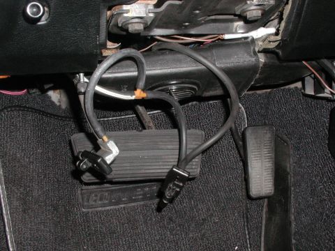1973 Chevrolet Corvette - Close-up of car pedals and wiring, with a "CORVETTE" logo visible on the floor mat.
