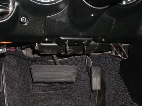 1973 Chevrolet Corvette - The interior footwell of a 1973 Chevrolet Corvette shows the brake and accelerator pedals, along with the floor mat.