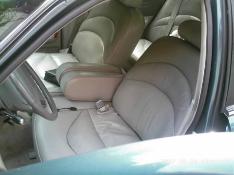 1995 Ford Crown Victoria - Interior of a 1995 Ford Crown Victoria, light gray leather seats and a center console.