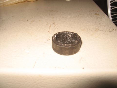 1979 Ford Bronco - A close-up view of a small, cylindrical metal part filled with grease.