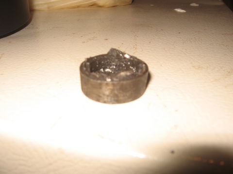 1979 Ford Bronco - A close-up view of a greasy metal part with visible wear and tear.
