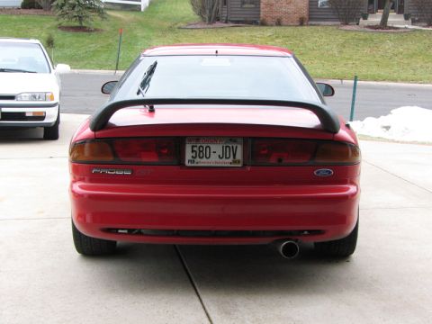 1993 Ford Probe - Rear view of a red 1993 Ford Probe GT, parked next to another vehicle.