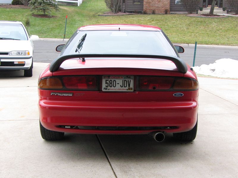 1993 Ford Probe GT rear view with spoiler and Wisconsin license plate 580-JDV. White car parked to the left