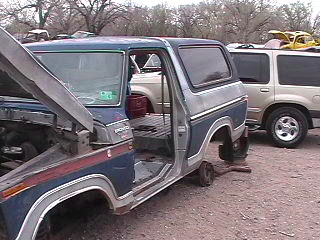 1979 Ford Bronco - This 1979 Ford Bronco appears to be in a junkyard, with its hood open and missing wheels.