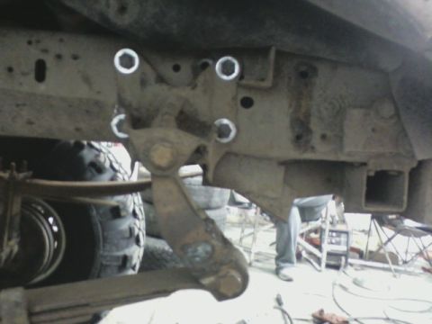 1992 Ford F-350 - Underside view of a truck's frame and suspension system, showing wear and tear.