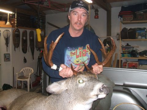 1974 Ford Ranchero - Man displays large deer antlers in a garage setting, with snowshoes and shelves visible in the background.