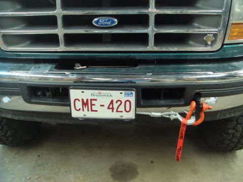 1996 Ford Bronco - Front view of a green Ford truck with a winch attachment and a New Brunswick license plate.