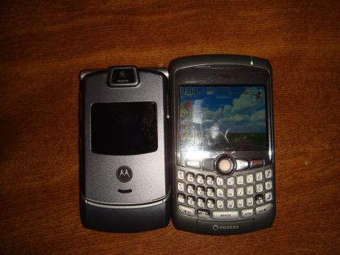 1996 Ford Bronco - A Motorola RAZR and a Blackberry are placed side-by-side on a wooden table.