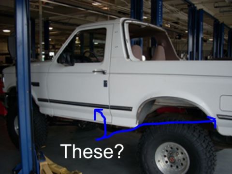 1992 Ford Bronco - White 1992 Ford Bronco on a lift, with blue lines indicating areas of interest on the body.