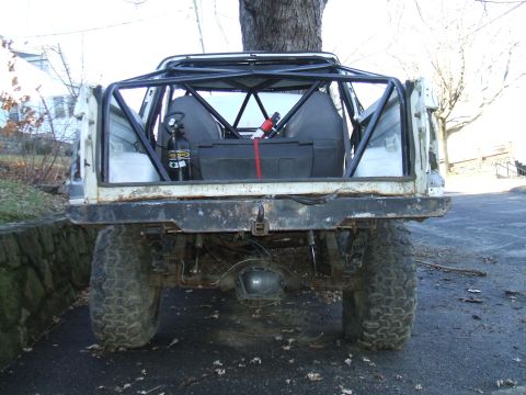 1995 Ford Bronco - This heavily modified vehicle features a prominent roll cage and off-road tires, suggesting it's built for terrain.