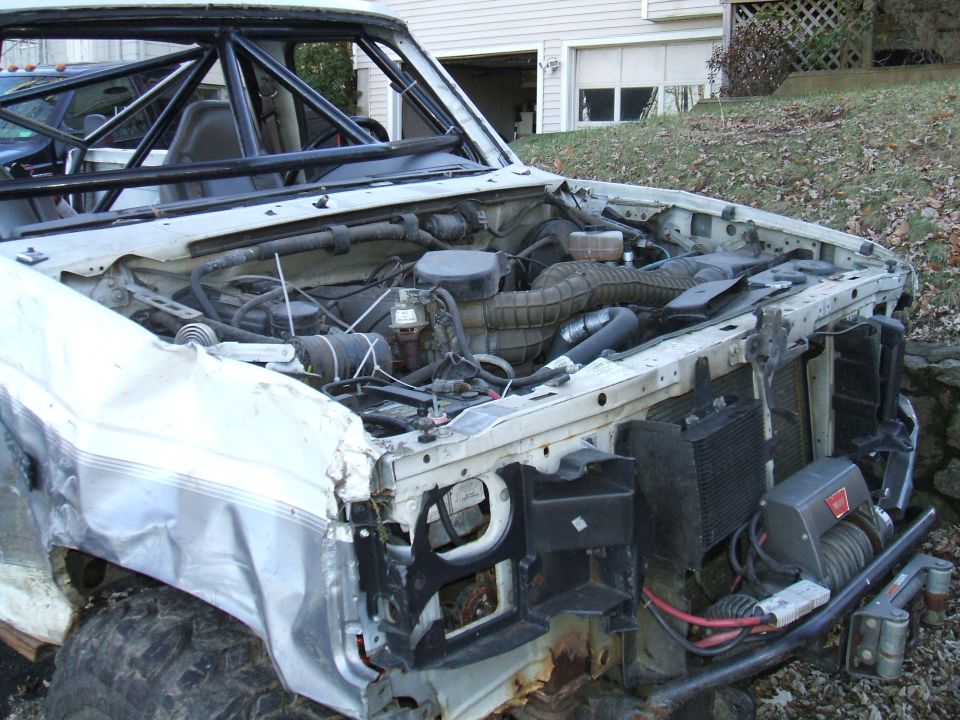 1995 Ford Bronco engine bay with roll cage and winch installed