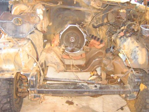 1986 Ford Bronco - This heavily corroded engine bay shows a disassembled engine and transmission components.