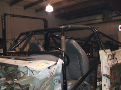 1995 Ford Bronco - Interior view of a vehicle undergoing modifications with a prominent roll cage structure.