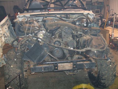 1995 Ford Bronco - The engine bay of a 1995 Ford Bronco is shown with the front end disassembled during a rebuild.