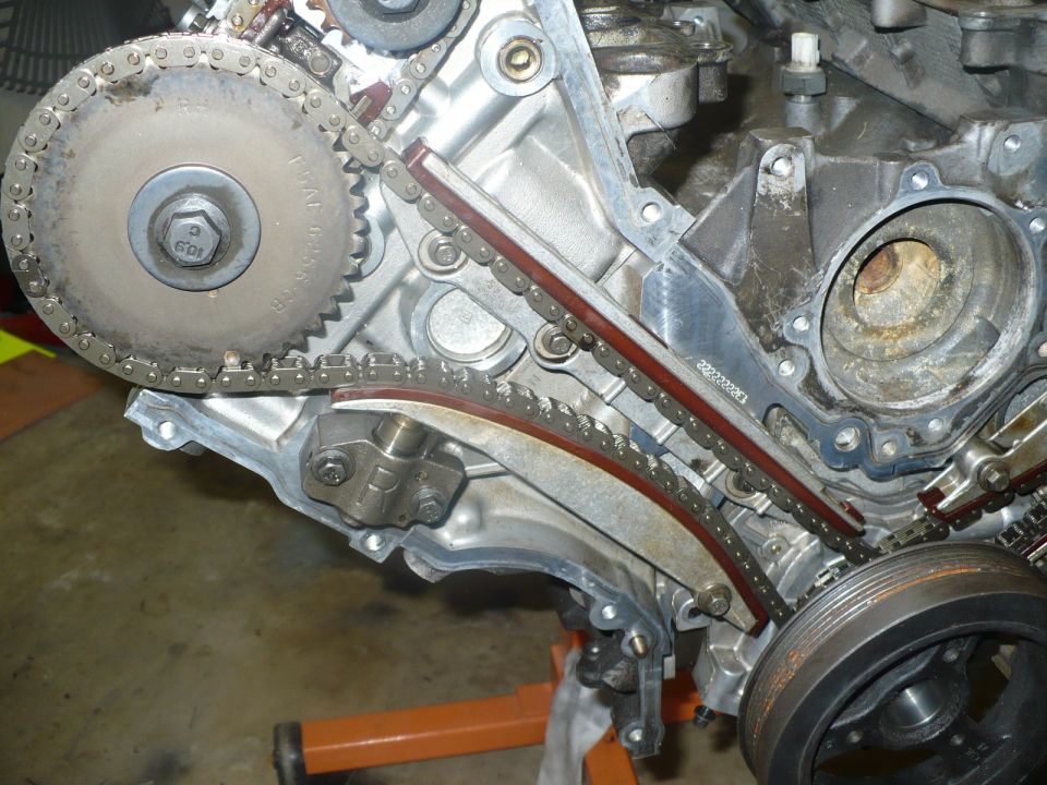 Front of a DOHC V engine showing timing chains and tensioners