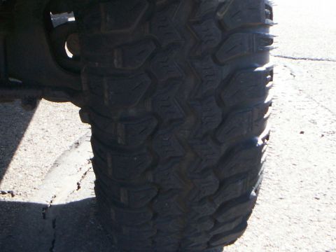 1992 Ford F-250 - A close-up view of a off-road tire with deep treads.