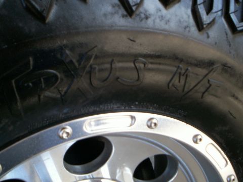 1992 Ford F-250 - Tire sidewall text reads 'TRYUS M/T' next to a portion of a custom alloy wheel.