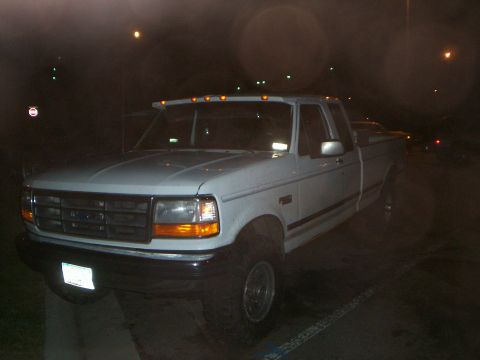 1992 Ford F-250 - This 1992 Ford F-250 is shown from a 3/4 front angle at night.