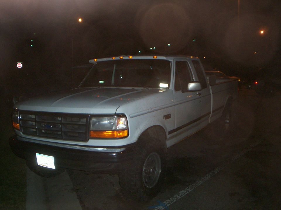 White 1992 Ford F-250 parked at night