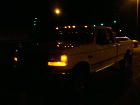 1992 Ford F-250 - This 1992 Ford F-250 pickup truck is visible at night, with its cab lights illuminated.