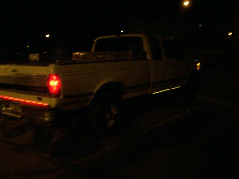 1992 Ford F-250 - This 1992 Ford F-250 pickup truck is seen from the side at night.