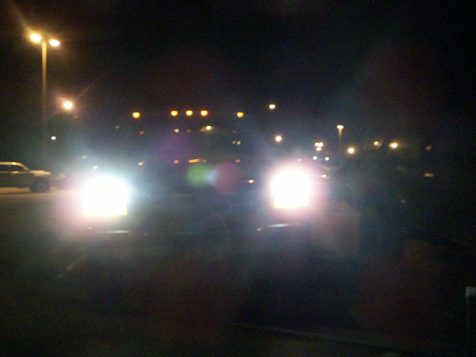 Two 1992 Ford F-250 trucks at night, headlights on, viewed from the front