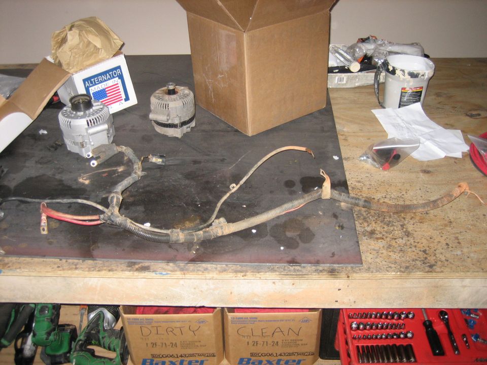 Alternators and battery cables laid out on a workbench