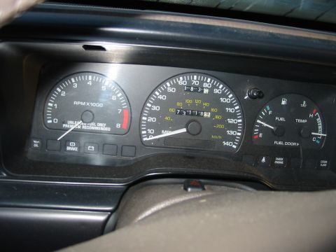 1993 Ford Taurus - Interior view of a car's dashboard, a speedometer, tachometer, fuel, and temperature gauges.