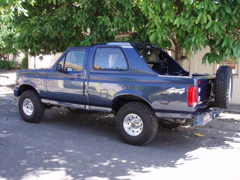 1995 Ford F-150 - This Ford Bronco features a removable top and a spare tire mounted externally on the rear.