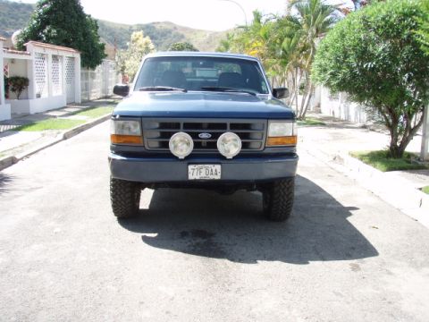 1995 Ford F-150 - Front view of a blue 1995 Ford F-150 pickup truck parked on a residential street.