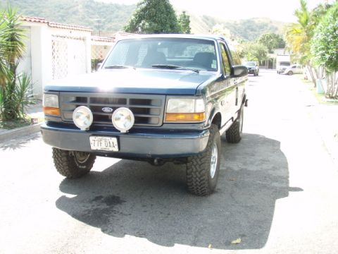 1995 Ford F-150 - This 1995 Ford F-150 is presented in a front-facing view, auxiliary lights and aftermarket wheels.
