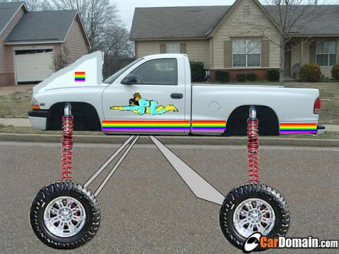 1989 Ford Bronco - A white pickup truck is decorated with rainbow stripes and decals, with its hood raised to reveal a rainbow flag.