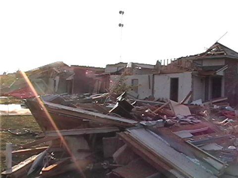 1979 Ford Bronco - Scene of destruction after a tornado, with damaged buildings and scattered debris.