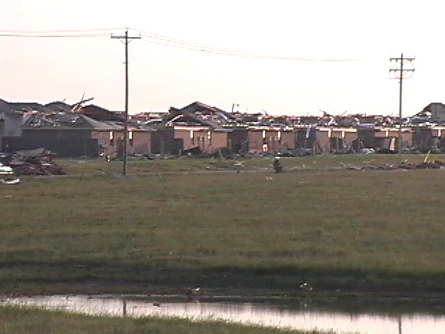 Damaged houses and debris in a neighborhood after a tornado