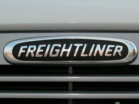 1990 Ford Bronco - Close-up of a Freightliner emblem on a truck's front grille.