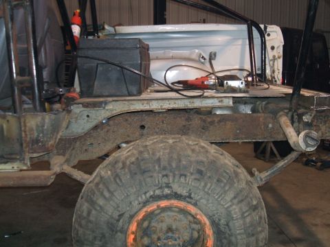 1995 Ford Bronco - Vehicle frame and large tire visible, suggesting ongoing repair or modification work.