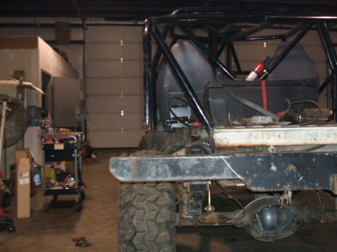 1995 Ford Bronco - Interior view of a modified off-road vehicle, showing roll cage and rear axle.