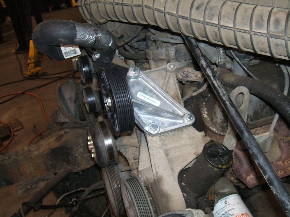 engine bay with new water pump and pulleys installed