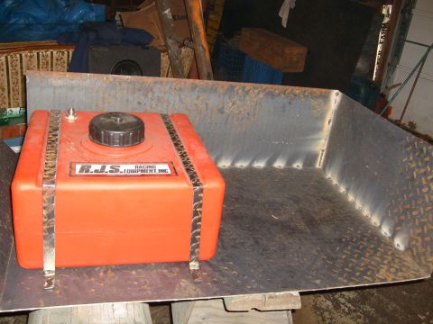 1974 Ford Bronco - An orange fuel tank with visible text sits inside a metal container.