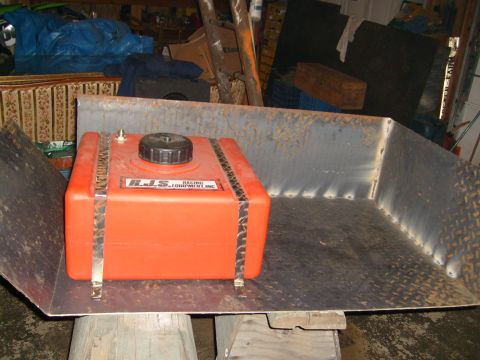 1974 Ford Bronco - Orange RJS Racing Equipment fuel tank in a metal tray, possibly for a race vehicle.