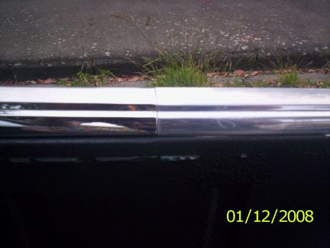 1970 Ford Falcon - Close-up of a chrome trim piece and black interior panel, with a date stamp visible.