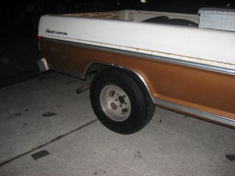 1972 Ford F-100 - This 1972 Ford F-100 pickup truck has a white and brown two-tone paint scheme and custom wheels.