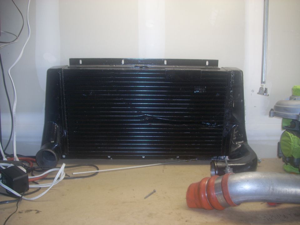 Black intercooler with silver piping and red couplers